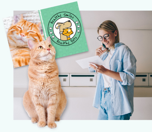 woman on phone, smiling, while looking at pet postcard featuring an orange cat