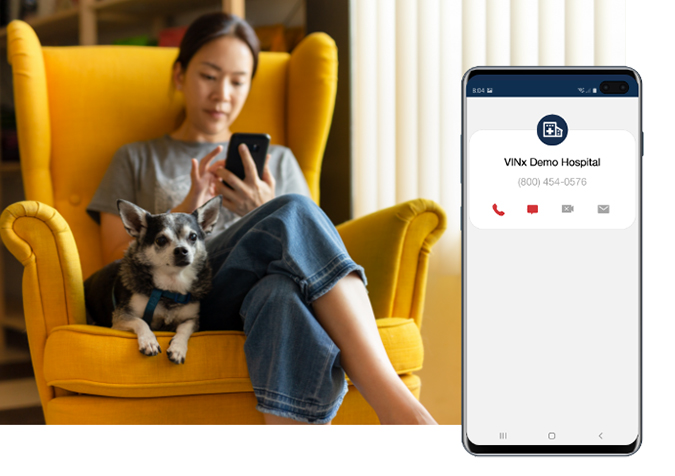 woman dialing smartphone with chihuahua seated beside her